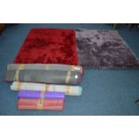 TWO MATCHING DUNELM RED GROUND RUGS, 160cm x 120cm, a similar violet rug, three other various rugs