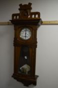 AN ART DECO WALNUT VIENNA WALL CLOCK, with an 8 day movement, the circular dial with Arabic numerals