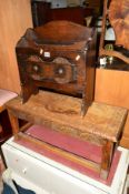 A LONG CARVED OAK FOOTSTOOL, together with an oak magazine rack (2)