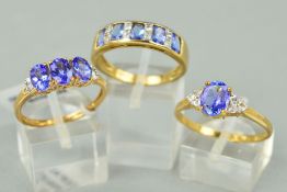 THREE 9CT GOLD TANZANITE DRESS RINGS to include a three stone oval mixed cut tanzanite with baguette