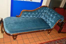 A VICTORIAN WALNUT CHAISE LONGUE, covered in blue buttoned upholstery, approximate width 180cm