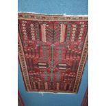 A 20TH CENTURY TURKISH WOOLLEN RED GROUND RUG, floral border, 200cm x 133cm, together with a similar