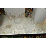 A QUANTITY OF CUT/ETCHED GLASSWARES to include decanters, bowls, glasses, etc