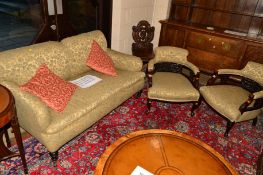 AN EDWARDIAN MAHOGANY THREE PIECE PARLOUR SUITE covered in green floral upholstery, comprising of