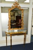 A REPRODUCTION GILT PAINTED AND MIRRORED CONSOLE TABLE with canted corners on cylindrical tapering