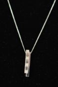 A 9CT WHITE GOLD DIAMOND PENDANT NECKLACE designed as two overlapping rectangular panels set with