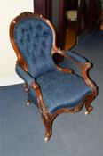 A VICTORIAN CARVED WALNUT BLUE UPHOLSTERED SPOON BACK ARMCHAIR
