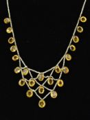 A SEED PEARL AND CITRINE FINE LATTICE STRUNG NECKLET, comprised of graduated mixed cut citrines to