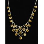 A SEED PEARL AND CITRINE FINE LATTICE STRUNG NECKLET, comprised of graduated mixed cut citrines to