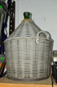 A LARGE CARBUOY with wicker wrap