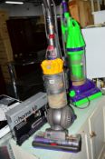 A DYSON DC40 UPRIGHT VACUUM CLEANER with boxed accessories