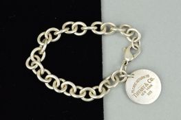 A TIFFANY & CO. SILVER BRACELET, the belcher link bracelet suspending a circular panel stamped '