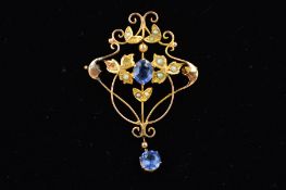 AN EARLY 20TH CENTURY 9CT GOLD SPLIT PEARL AND BLUE PASTE BROOCH of openwork design, the central