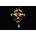 AN EARLY 20TH CENTURY 9CT GOLD SPLIT PEARL AND BLUE PASTE BROOCH of openwork design, the central