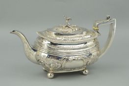 AN EARLY 19TH CENTURY SILVER TEAPOT OF OVAL FORM, engraved inscription to base, later foliate