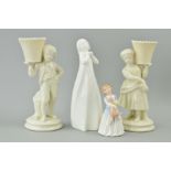 A PAIR OF BELLEEK FIGURAL SPILL VASES, shaped as boy and girl carrying a basket, blue backstamp,
