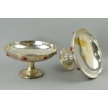 A PAIR OF SILVER PLATED ARTS & CRAFTS PEDESTAL BOWLS/TAZZAS, with eight red cabochons inset to the