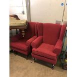 A PAIR OF RED UPHOLSTERED WING BACK ARMCHAIRS