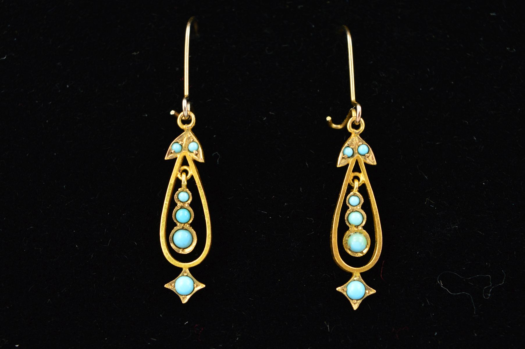 A PAIR OF DROP EARRINGS, each designed as an open pear shape drop, the central suspended panel set