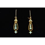 A PAIR OF DROP EARRINGS, each designed as an open pear shape drop, the central suspended panel set