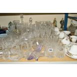 A LARGE PARCEL OF CUT GLASS etc to include drinking glasses, decanters, rose bowls, vases and