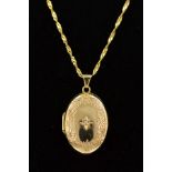 A 9CT GOLD LOCKET AND CHAIN, the oval locket with scrolling decoration to the front edge and a