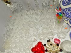 A QUANTITY OF CUT GLASS, etc to include red wine glasses, water jugs, decanters, a silver brandy