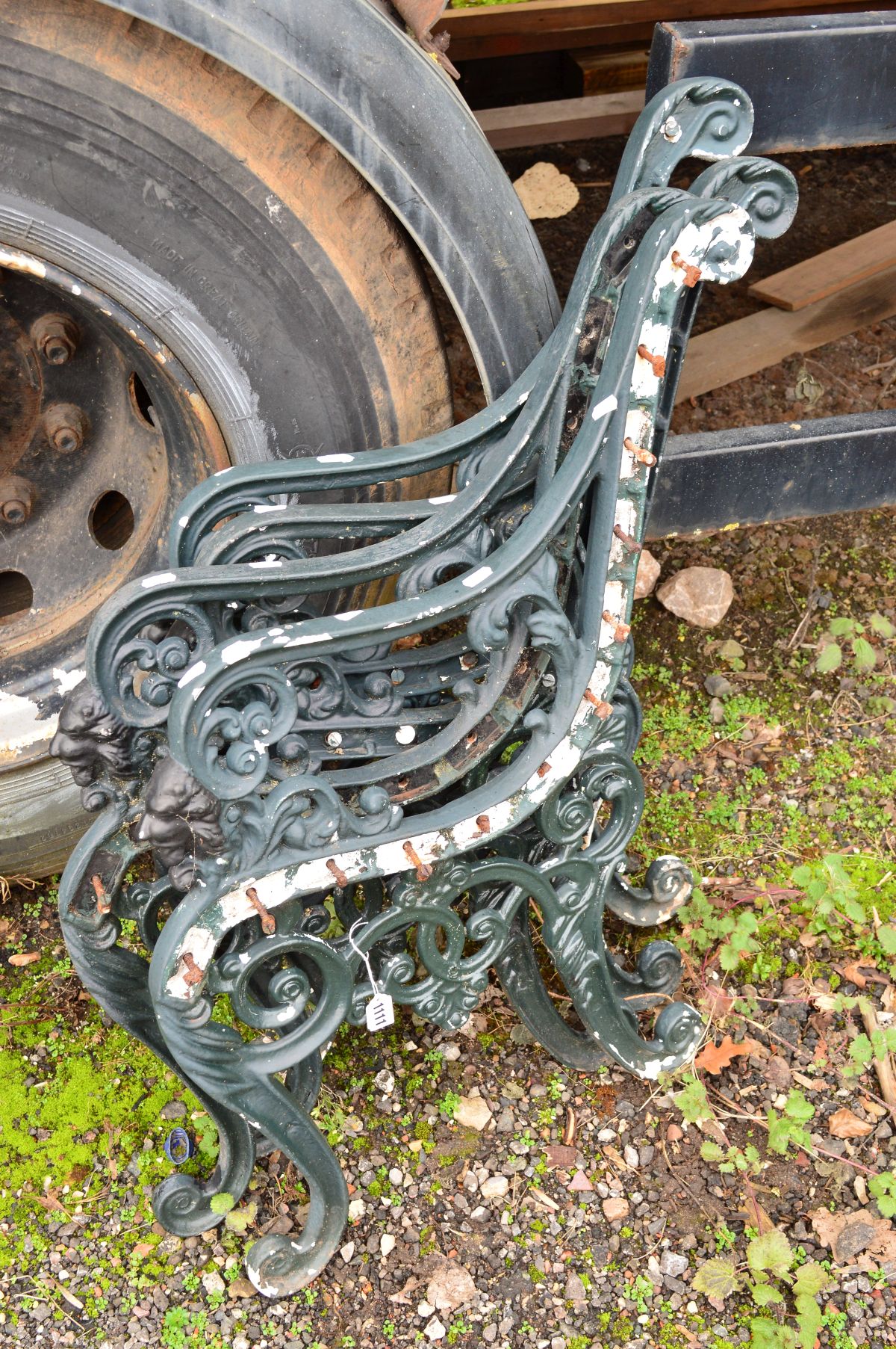 A SET OF DARK GREEN PAINTED METAL BENCH ENDS with scrolled design and small lion face to front (4)