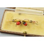 AN EARLY 20TH CENTURY GOLD BAR BROOCH, designed with two enamelled berries to the bar brooch,