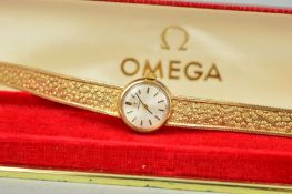 A 9CT GOLD LADY'S OMEGA WRISTWATCH WITH MAKERS CASE, the circular face with baton hour markers to