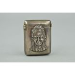 A LATE VICTORIAN SILVER VESTA CASE, embossed to the front with the image of a smiling lady, engraved