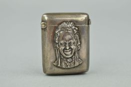A LATE VICTORIAN SILVER VESTA CASE, embossed to the front with the image of a smiling lady, engraved