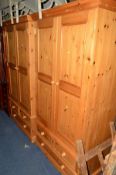 TWO PINE DOUBLE DOOR WARDROBES above three various drawers, approximate width 105cm x depth 60cm x