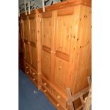 TWO PINE DOUBLE DOOR WARDROBES above three various drawers, approximate width 105cm x depth 60cm x