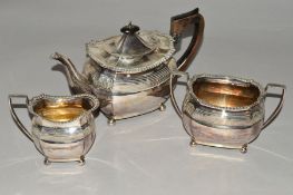 A LATE VICTORIAN SILVER THREE PIECE TEASET, of shaped oval form, gadrooned rims, banded and