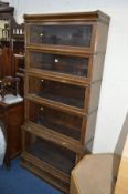 AN OAK GLOBE WERNICKE FIVE SECTION BOOKCASE with glazed fall front doors, approximate width 87cm x