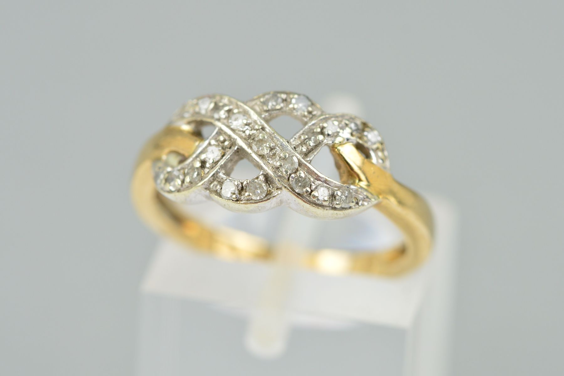 A 9CT GOLD DIAMOND DRESS RING, the interlinking design set with single cut diamonds, with 9ct