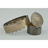 AN EARLY 20TH CENTURY SILVER BANGLE AND A LATE VICTORIAN PILL BOX, the front half bangle engraved
