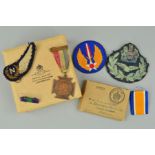 A BOX CONTAINING AN ISSUE BOX FOR WWII MEDALS, a length of ribbon for WWI War medal, a US military