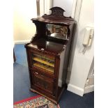 AN EDWARDIAN MAHOGANY MUSIC CABINET with bevelled mirror back, width 49cm