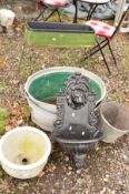 A METAL PLANTER ON A STAND, two galvanised bath tubs and a bucket, a painted metal water feature