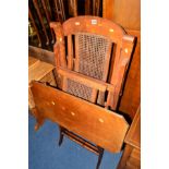 AN EDWARDIAN WALNUT CANE SEATED FOLDING STEAMER CHAIR, together with a folding walnut occasional