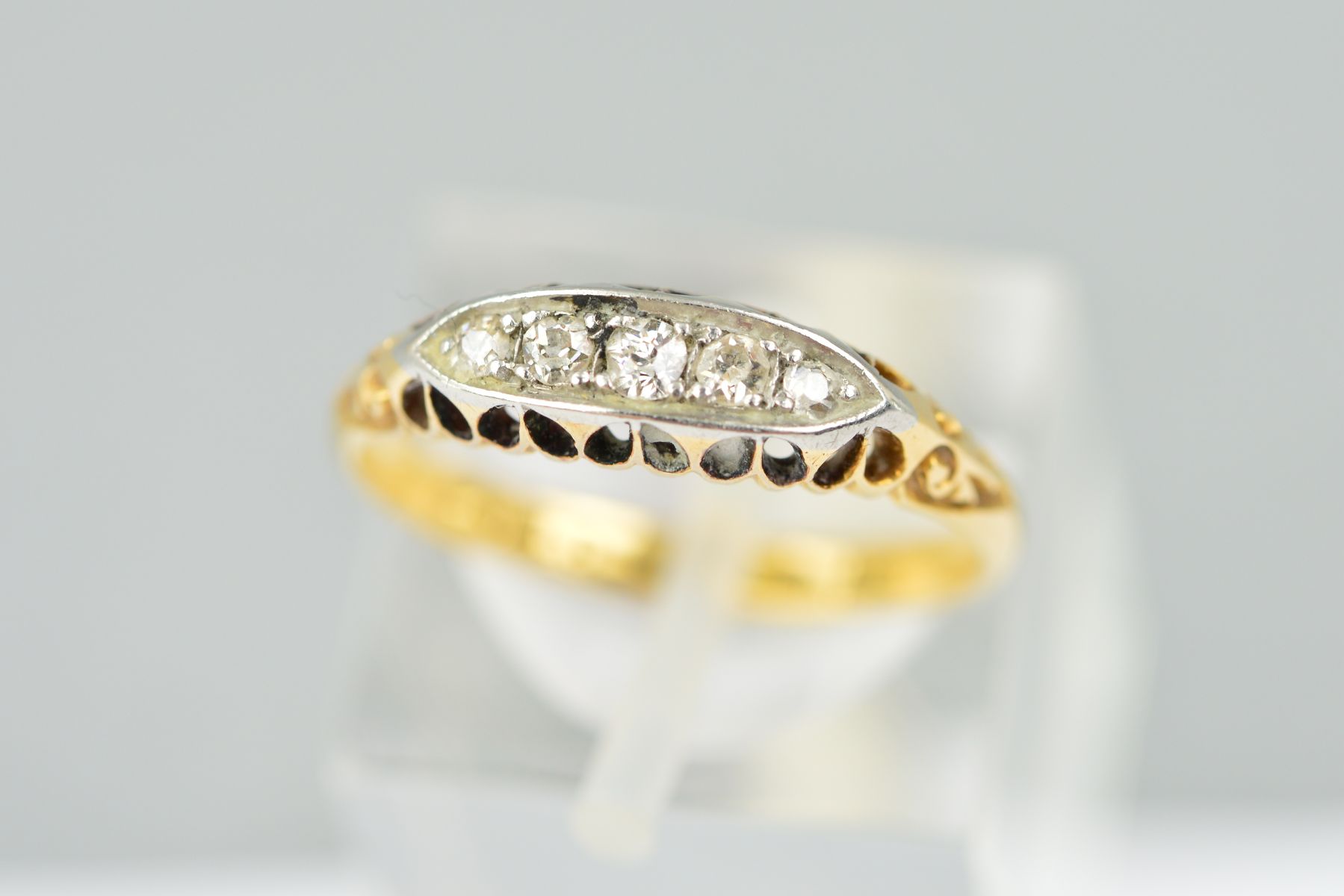 A GOLD EARLY 20TH CENTURY DIAMOND HALF HOOP RING, five old Swiss and eight cut diamonds totalling