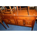 AN EDWARDIAN MAHOGANY SIDE CABINET with two drawers above four panelled doors, width 123cm x depth