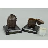 TWO WWII ERA BRITISH HAND GRENADE CASTINGS FASHIONED INTO ASHTRAYS/INKWELLS, mounted on a plinth,