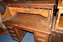 A 20TH CENTURY OAK ROLL TOP DESK with eight various drawers, approximate width 122cm x depth 66cm