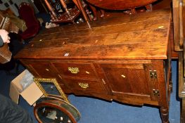 A REPRODUCTION GEORGIAN STYLE OAK SIDEBOARD with two short drawers raised on turned legs united by a