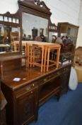 AN EDWARDIAN OAK MIRROR BACK SIDEBOARD with three various drawers and double panelled doors,