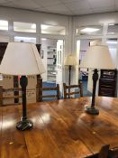 A MODERN DECORATIVE METAL STANDARD LAMP together with a pair of matching table lamps (all with