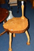 A NATURALISTIC HARDWOOD OCCASIONAL TABLE on triple legs with attached lamp